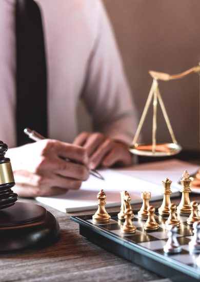 Legal law, advice and justice concept, Professional male lawyers working on courtroom sitting at the table and signing papers with gavel and Scales of justice.
